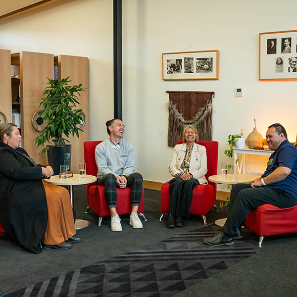 Podcast panelists sitting on chairs