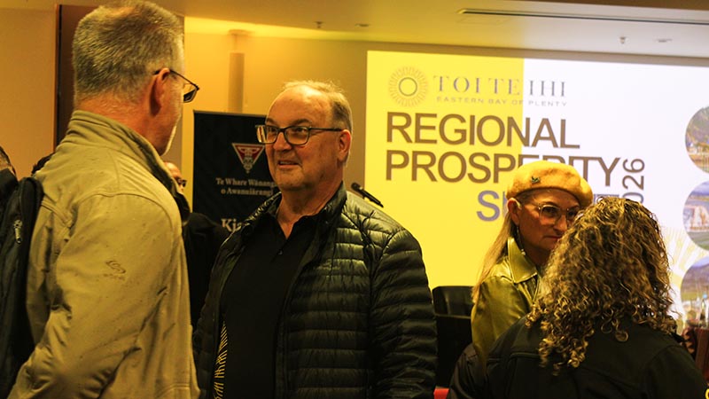 David Glover speaks with people at the summit